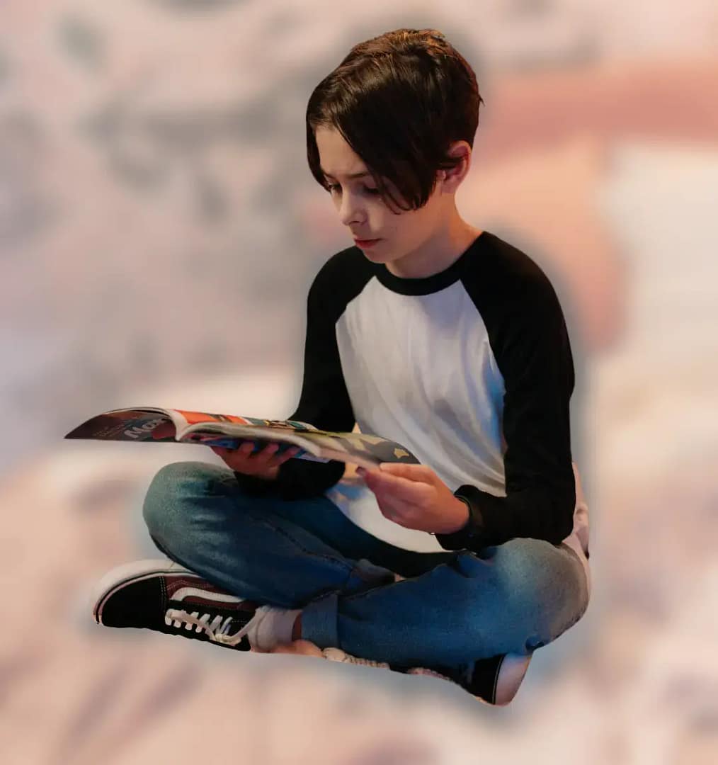 Child-reading-CurioBuddy-magazine-1 - CurioBuddy Child engrossed in reading CurioBuddy magazine at home