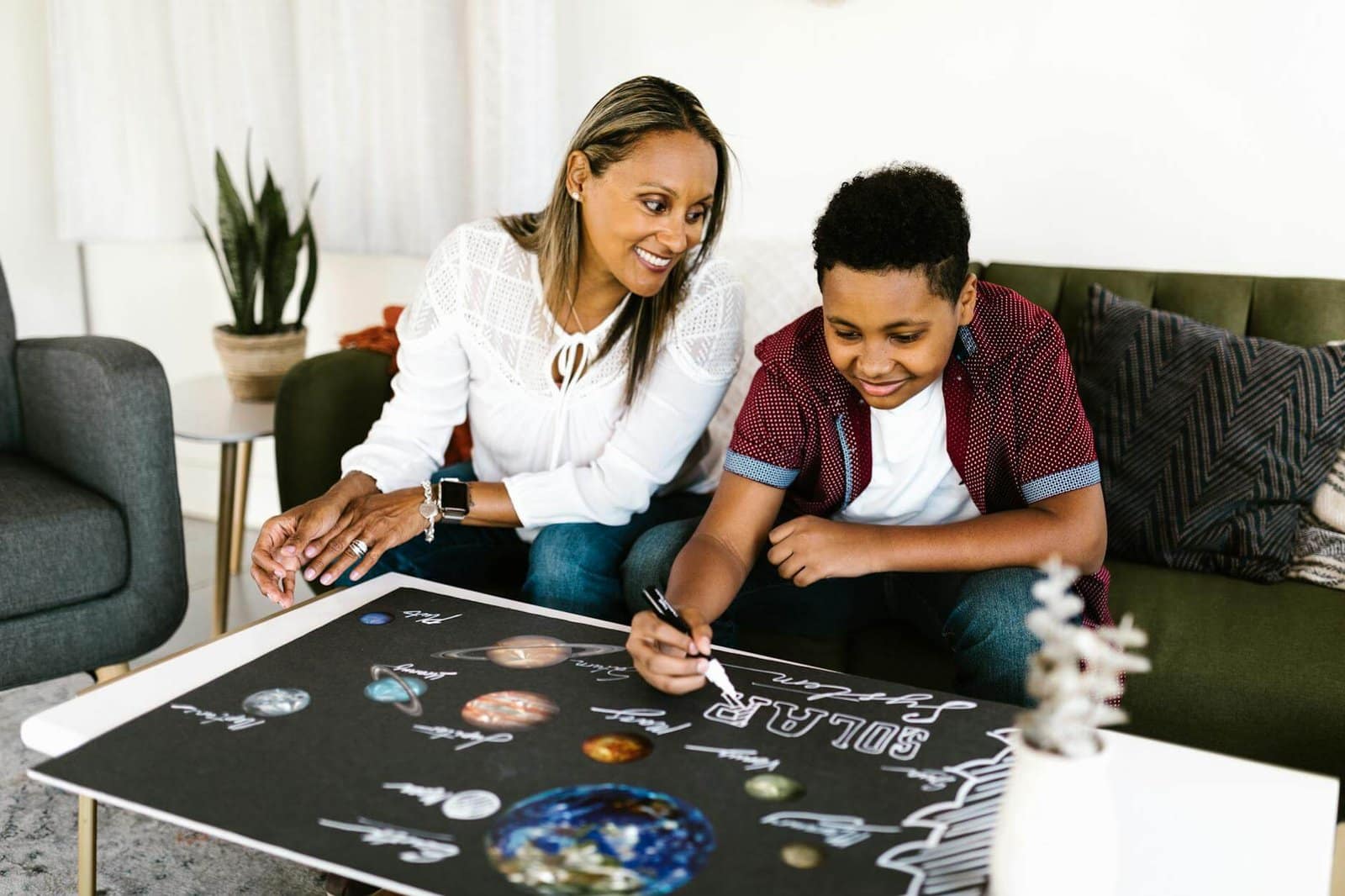 Let's Make Poster - CurioBuddy a young boy making poster at home with happy parent. Enter the #CreateWithCB event today.